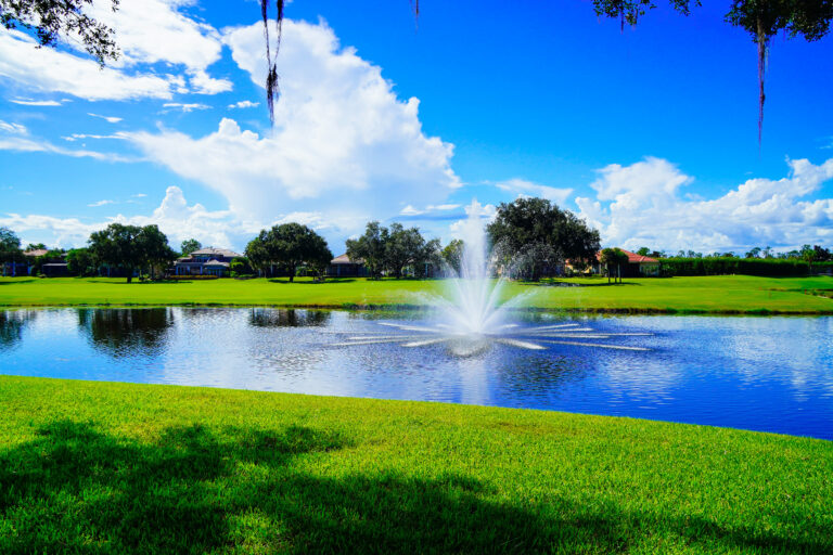 Florida blue sky, lake, fountain and house